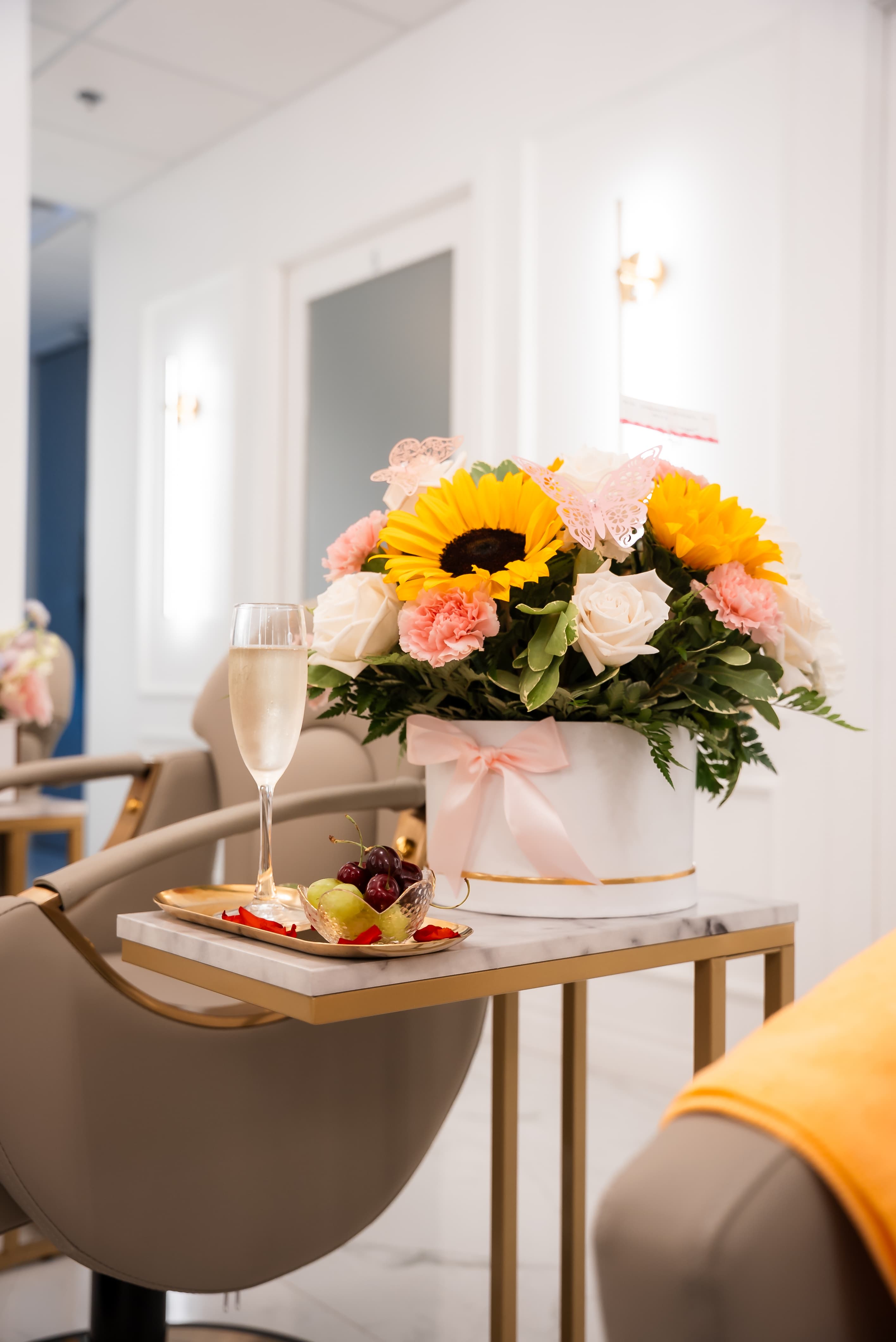 Bright head spa welcome area with champagne and floral arrangements